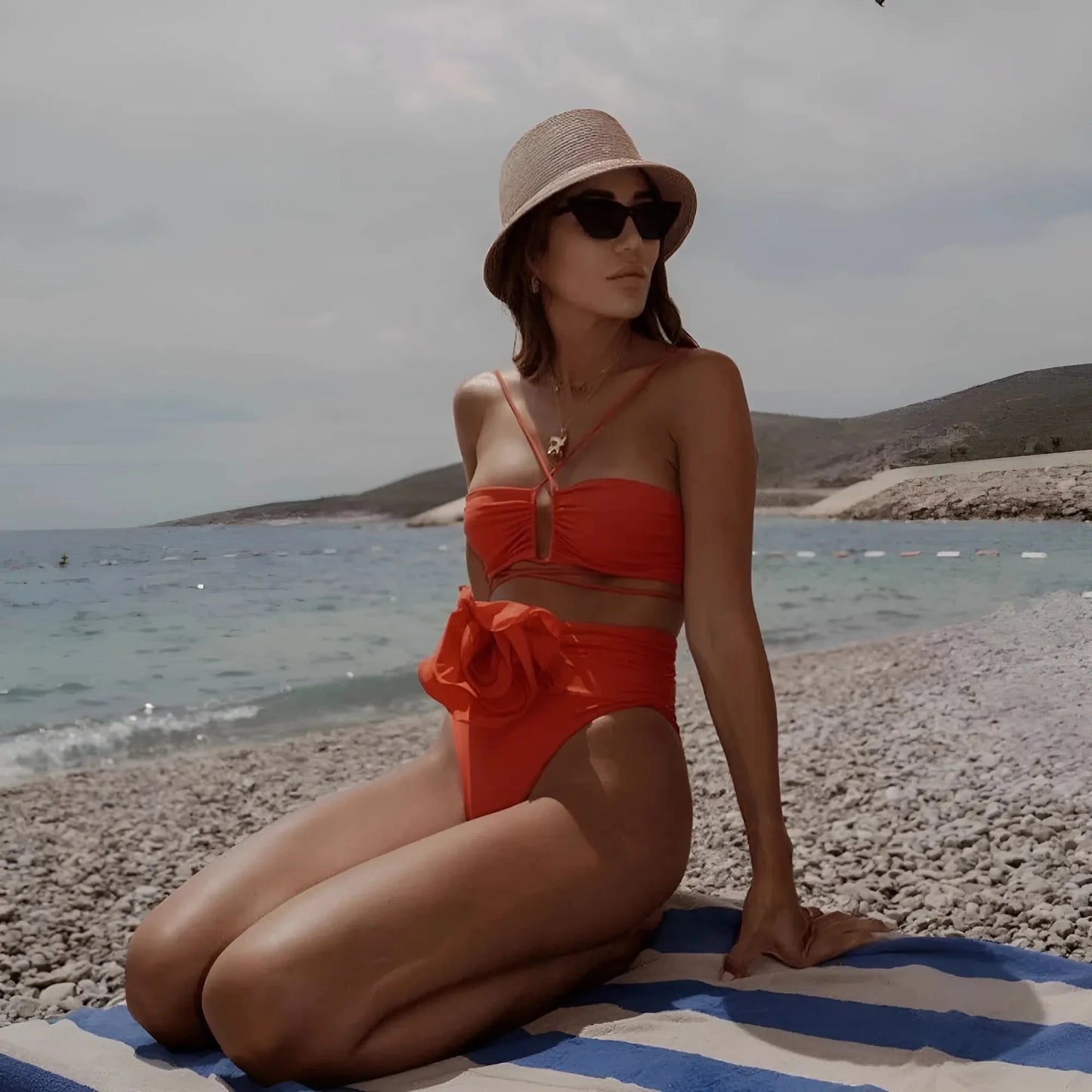 Two-piece bikini swimsuit with ties and decorative flower